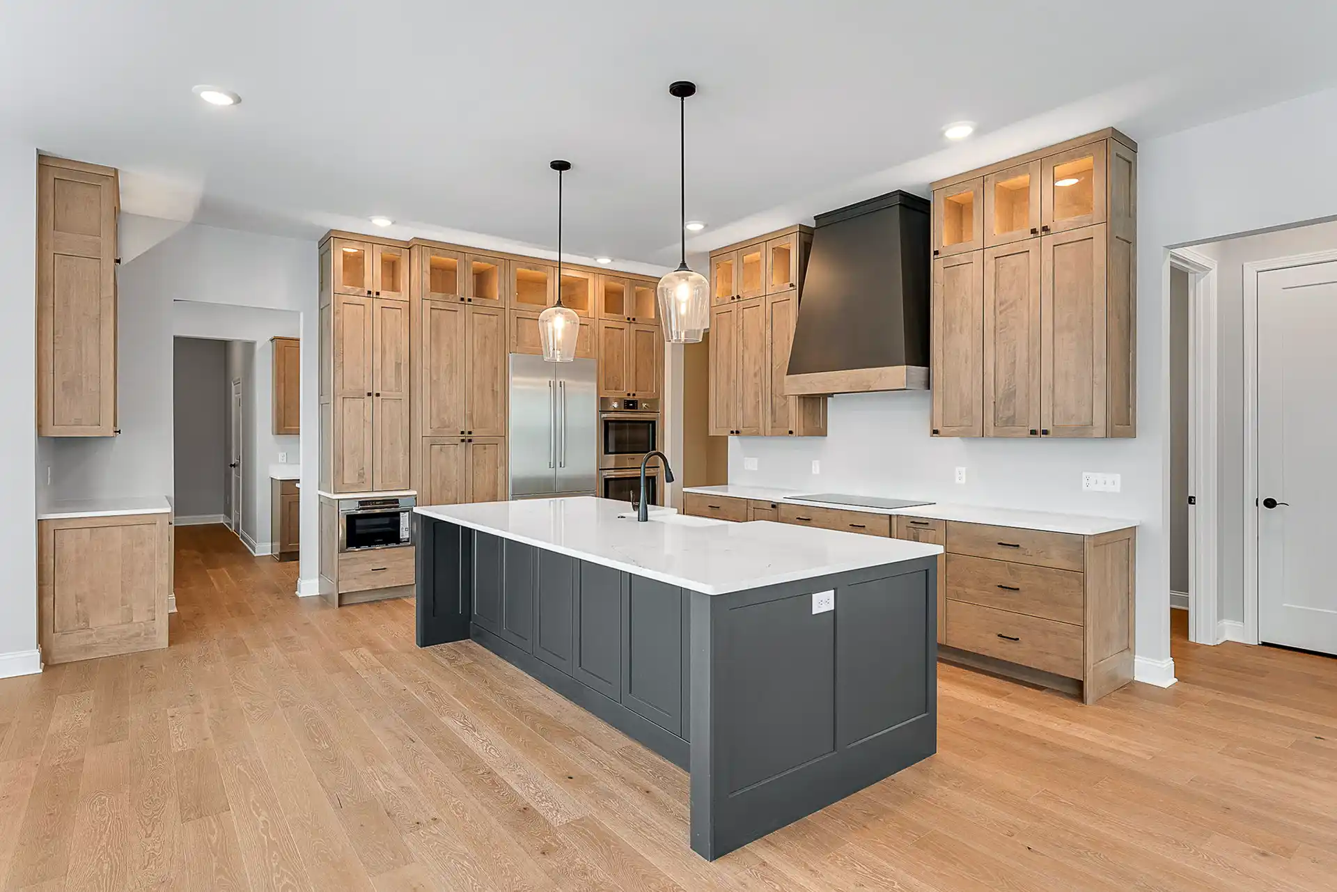 Large kitchen with wood cabinets and a black island