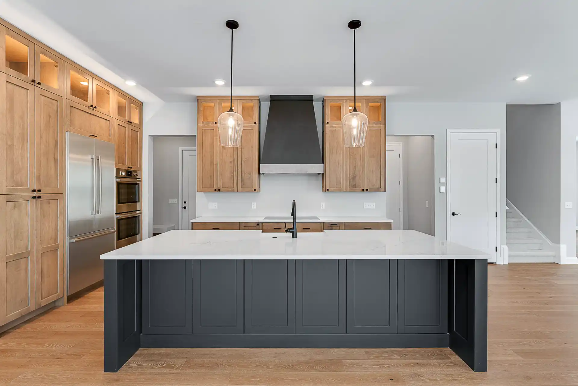 Large kitchen with wood cabinets and a black island