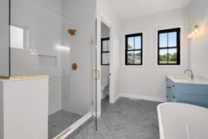 Bathroom with blue vanity and grey tile