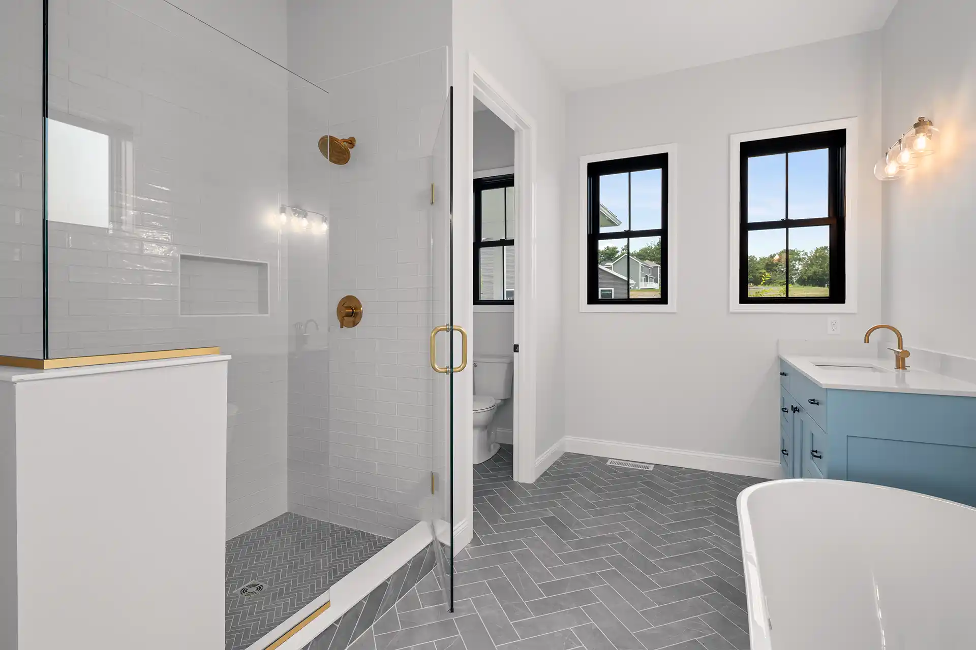 Bathroom with blue vanity and grey tile
