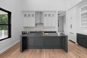 Large kitchen with black island and white cabinets