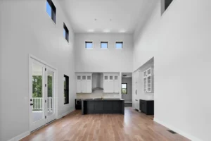 Large open room with black and white kitchen