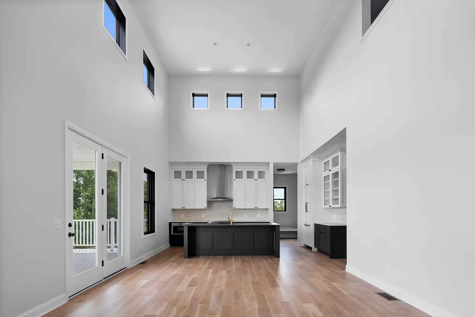 Large open room with black and white kitchen