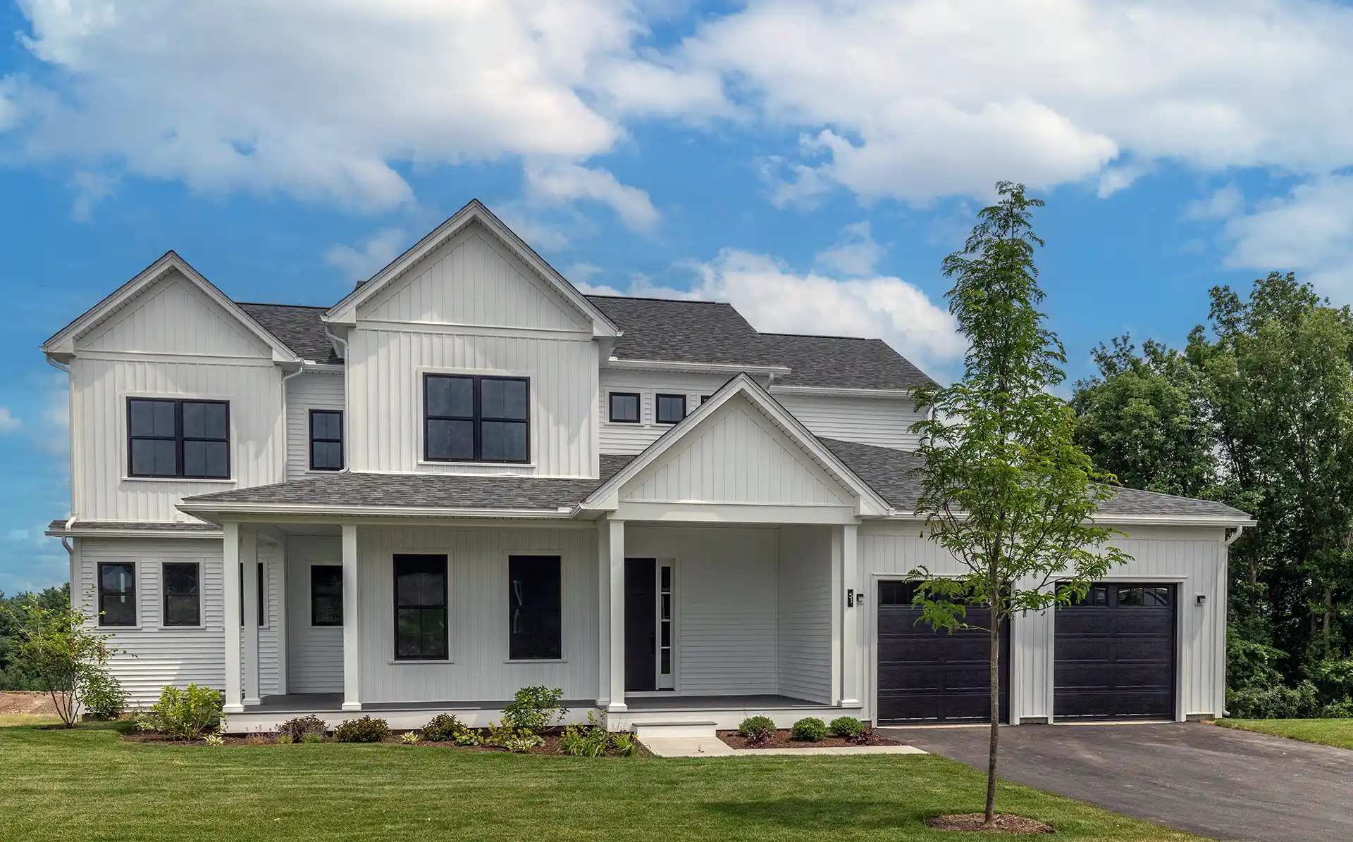 Large white home with black windows and doors
