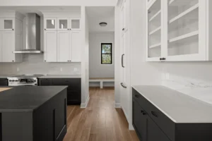 black lower cabinets white upper range hood mudroom bench