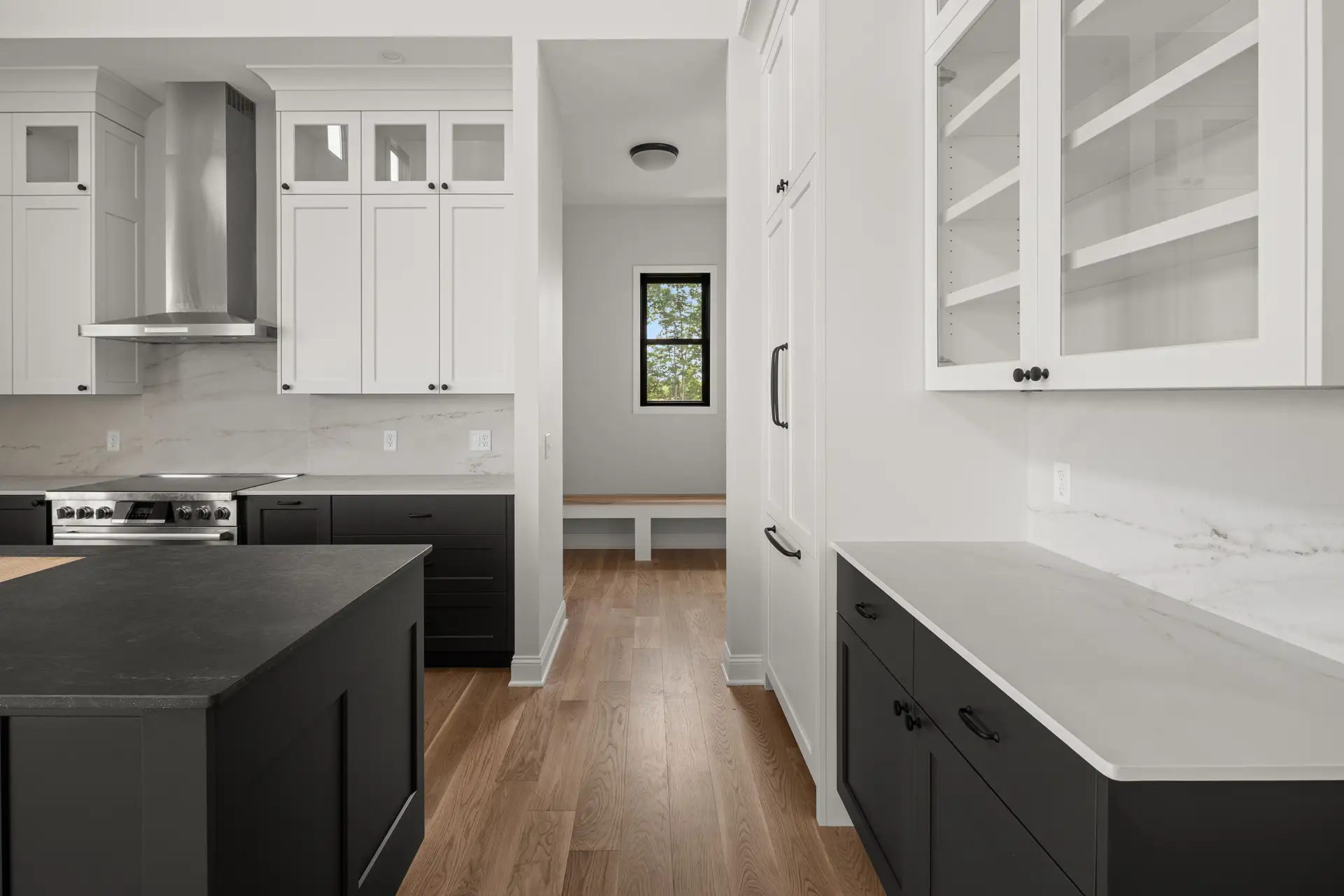black lower cabinets white upper range hood mudroom bench