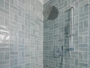 blue gray tile shower with rain head and handheld