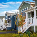 colorful row of homes with raised porches and autumn foliage