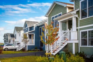 colorful row of homes with raised porches and autumn foliage