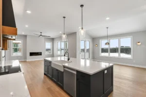 dark island sink open living area linear fireplace winter