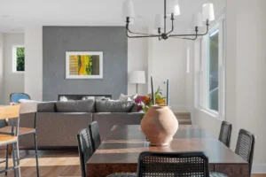 dining area open to living room with gray accent fireplace wall
