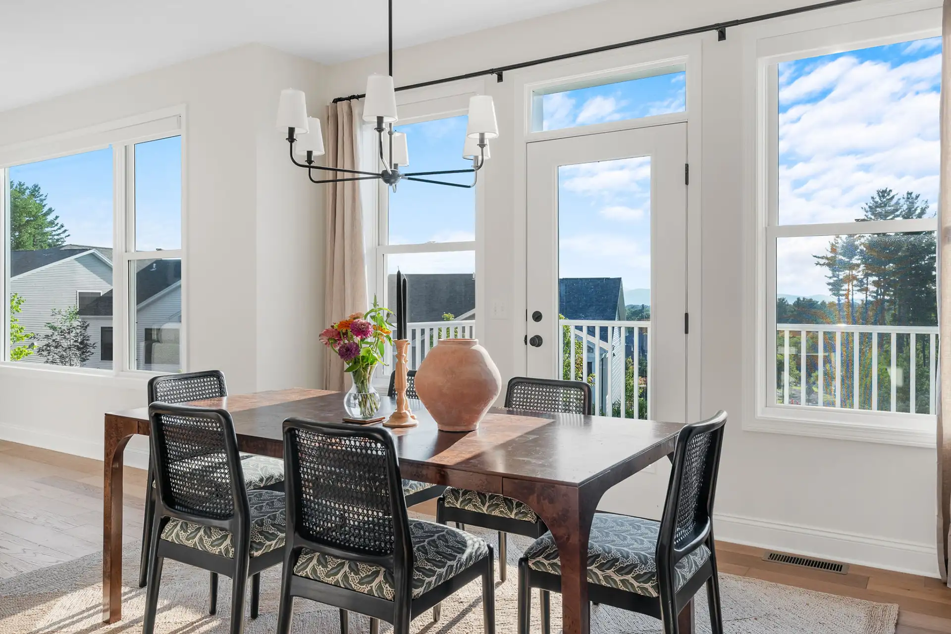 dining room with cane chairs chandelier and mountain view french door