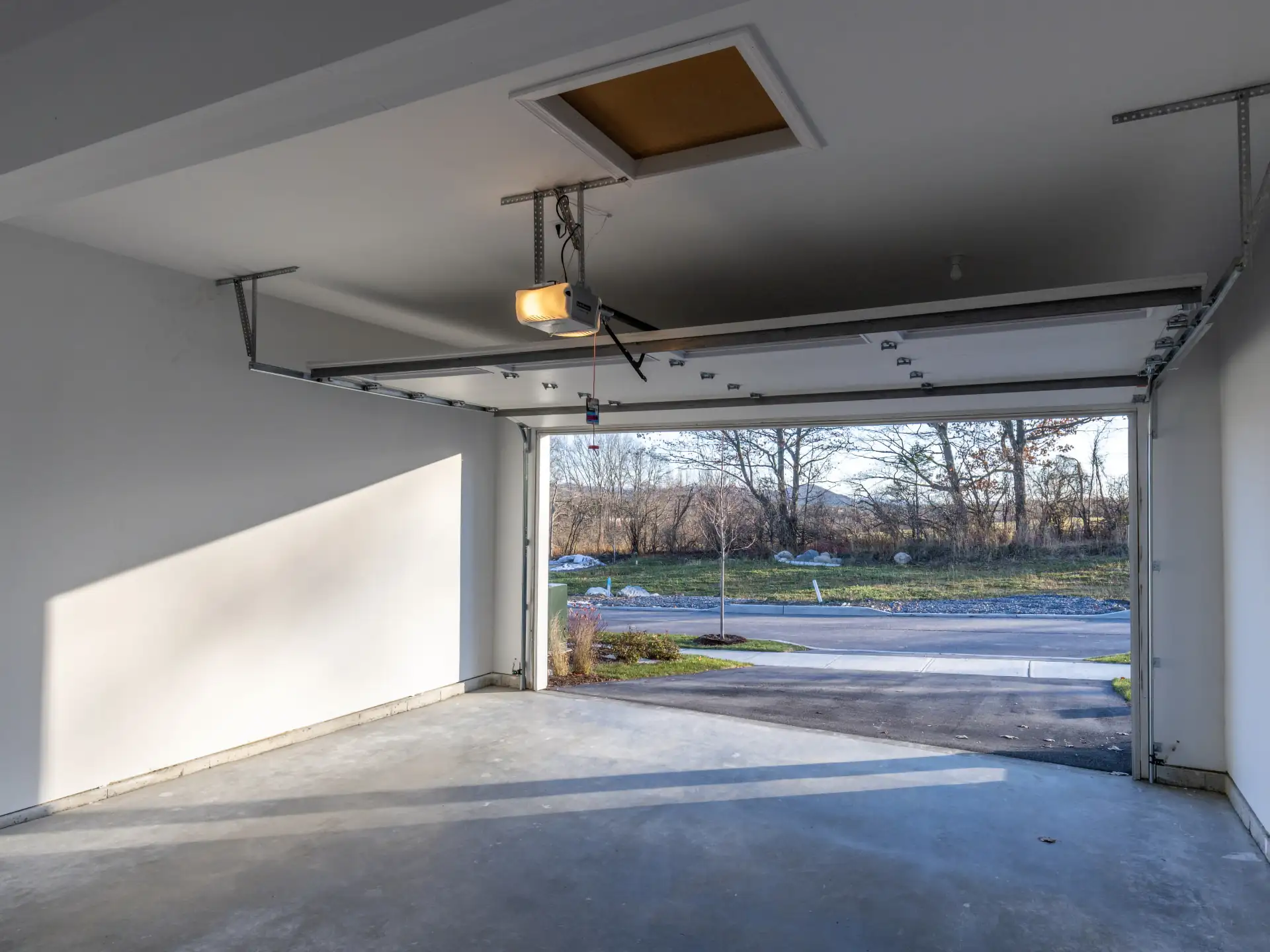 empty garage interior open door driveway view
