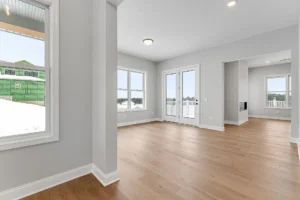 empty living room with french doors to deck and hardwood floors