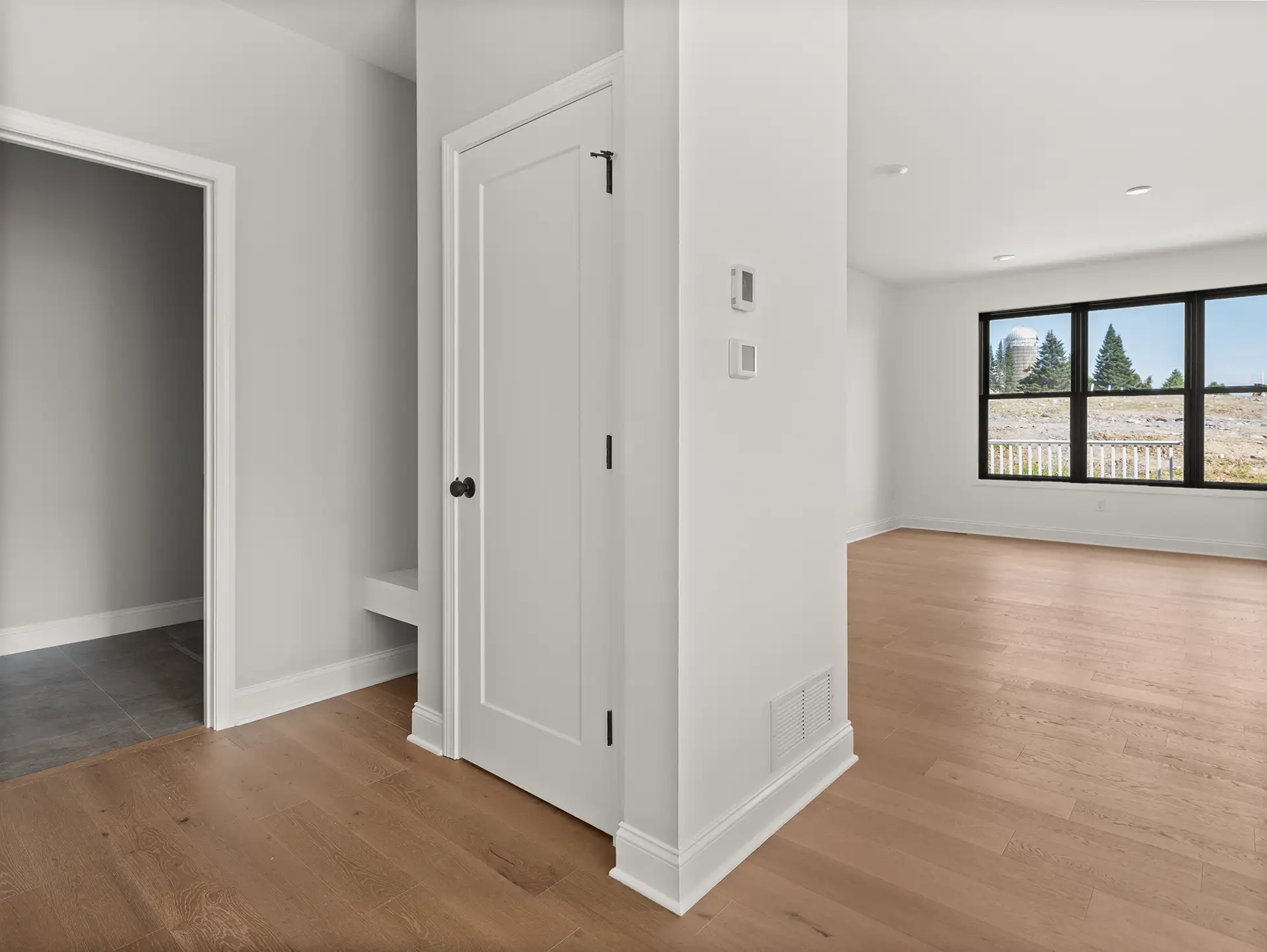 entryway closet door hardwood floor black window farm view