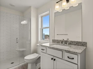 granite countertop vanity white subway tile shower