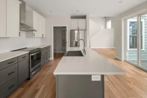 gray island white upper cabinets subway tile pantry sliding door