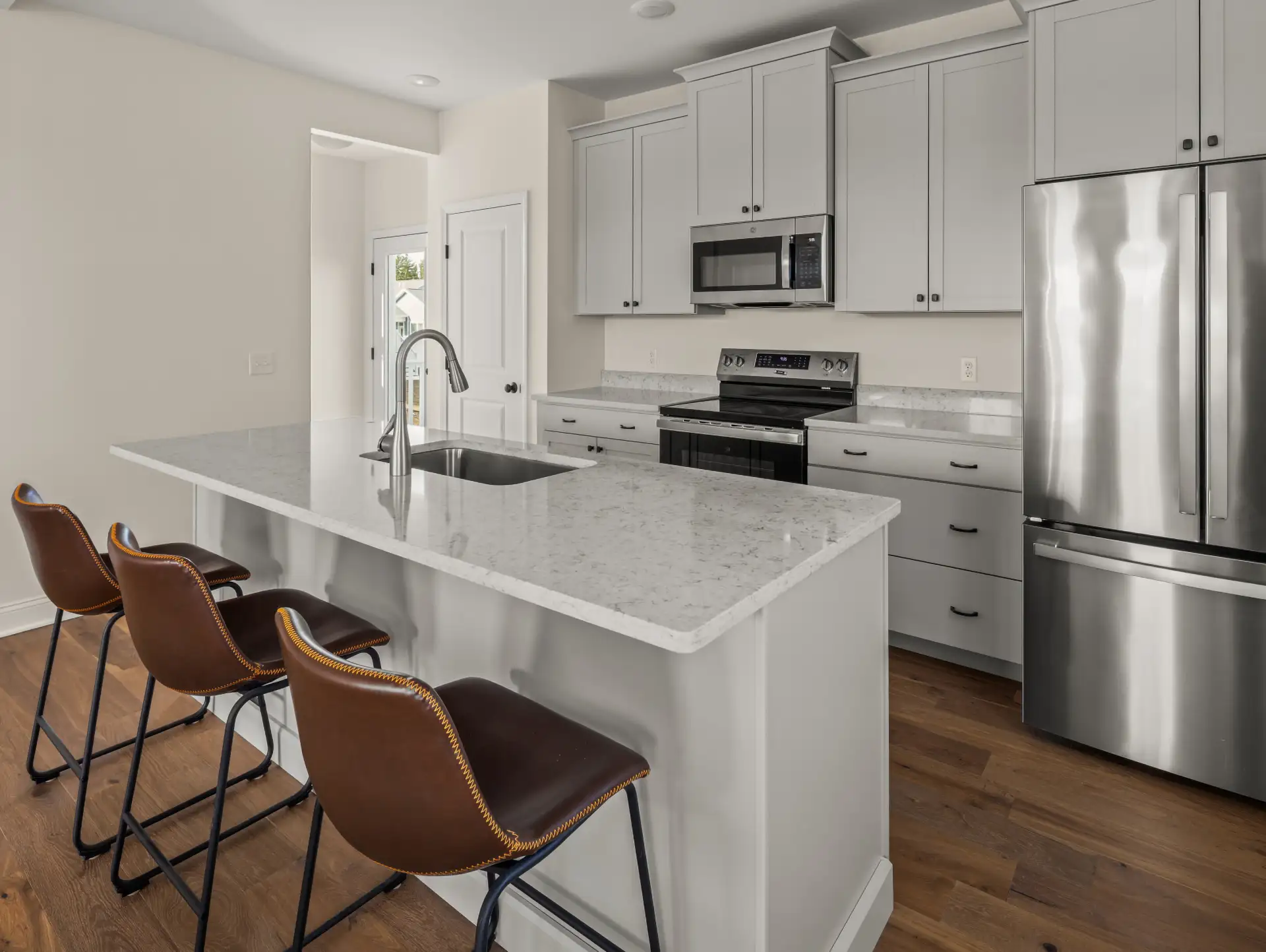 gray kitchen island leather barstools angled view french door