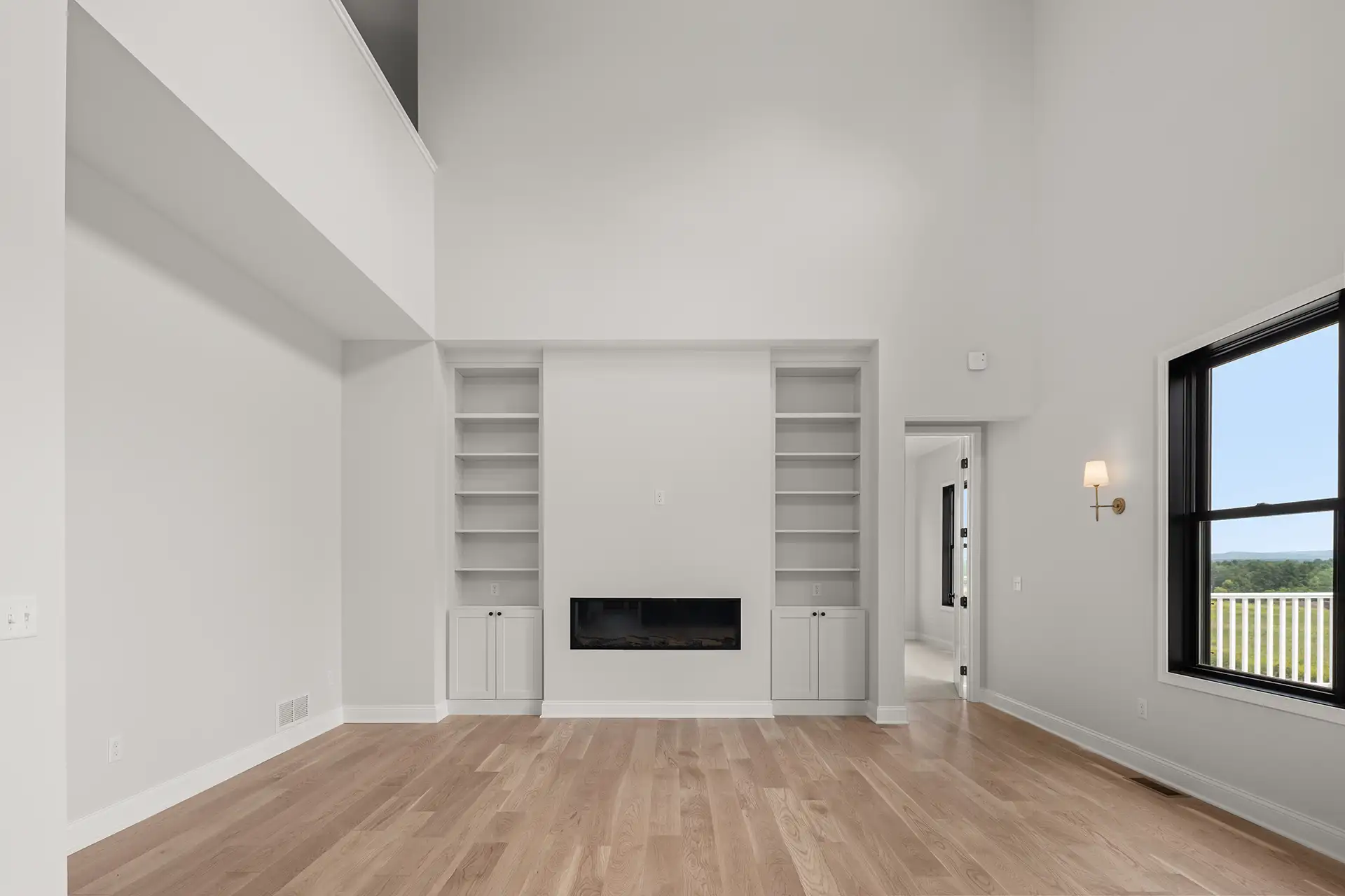 great room built in shelves flanking linear fireplace