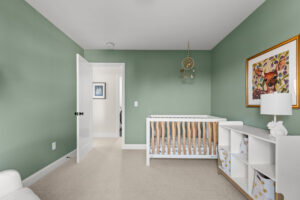 green nursery with crib dream catcher mobile and cubby dresser