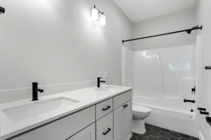grey and black vanity tub shower combo bathroom