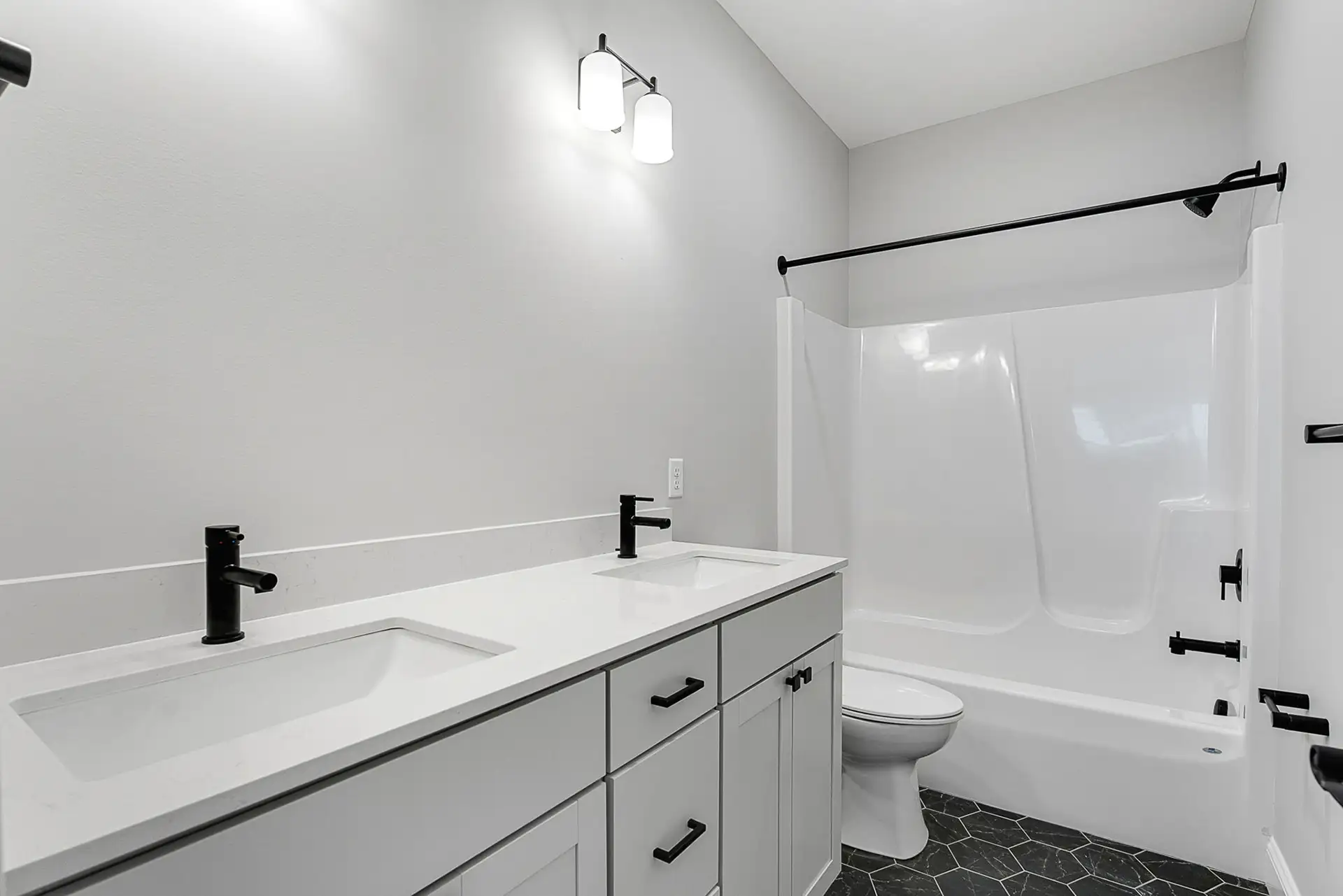 grey and black vanity tub shower combo bathroom