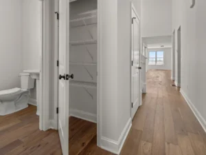 hallway open linen closet wire shelves powder room view