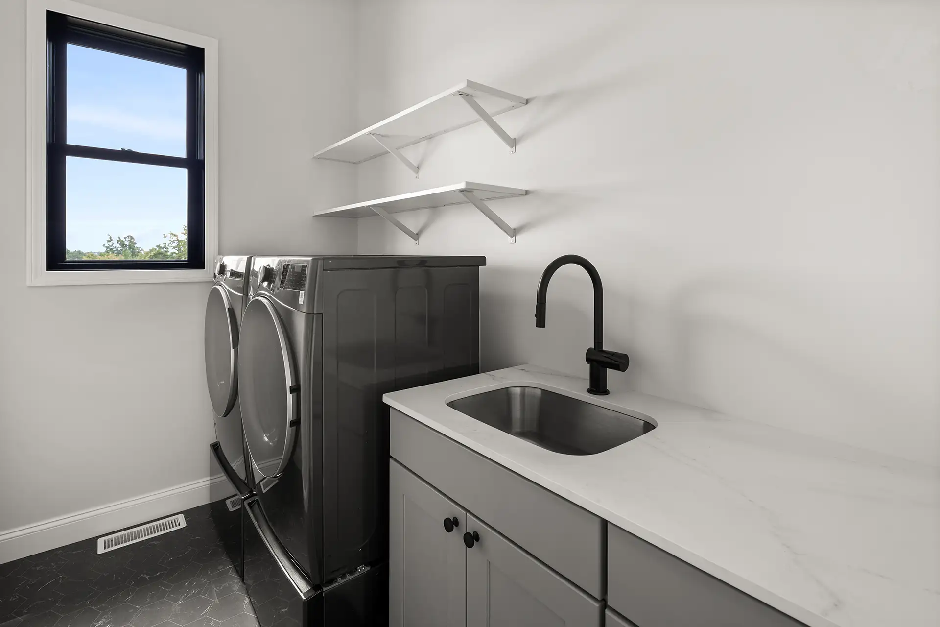 laundry room dark washer dryer sink marble counter shelves