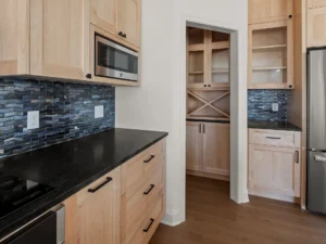 light wood kitchen blue backsplash pantry wine rack
