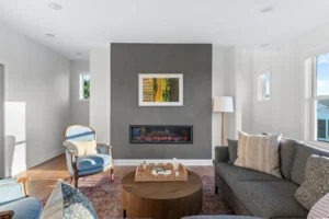 living room with gray concrete fireplace wall art and sectional
