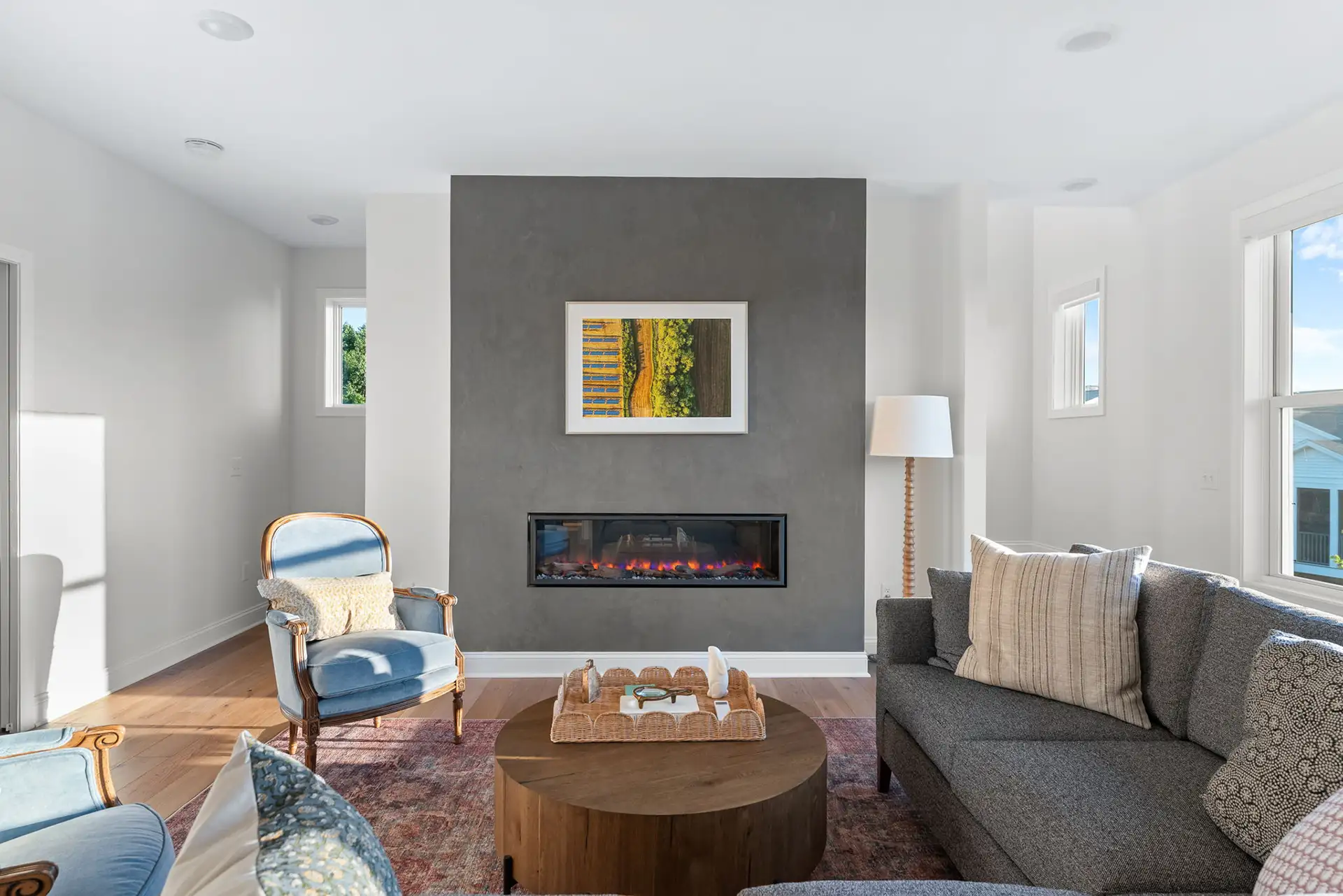 living room with gray concrete fireplace wall art and sectional