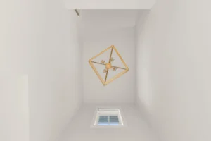 looking up stairwell gold geometric chandelier skylight
