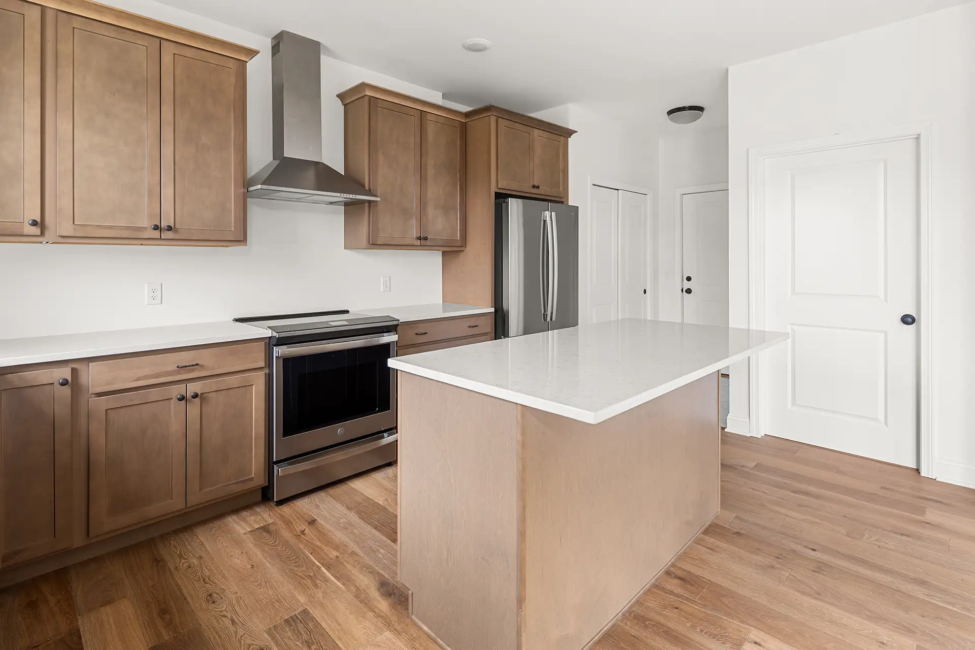 medium wood kitchen range hood stainless appliances plain island