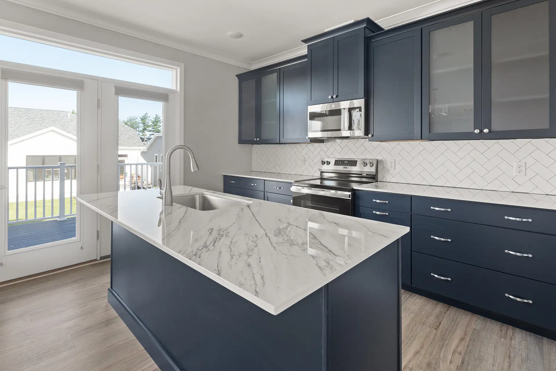 navy kitchen island closeup marble countertop herringbone tile