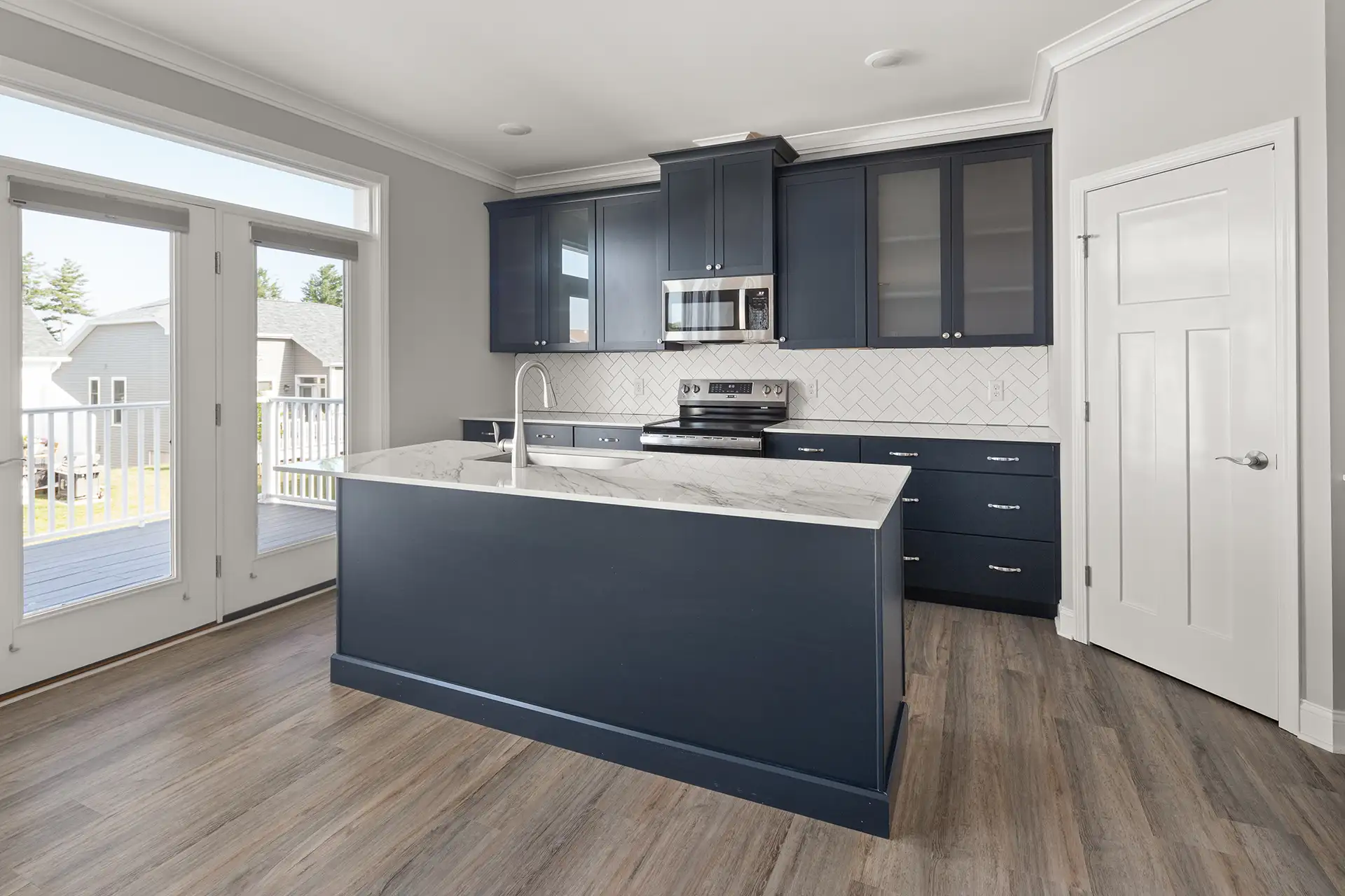 navy kitchen island herringbone backsplash marble countertop deck door