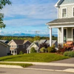 neighborhood street with mountain view and wrap porch home