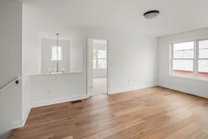 open hallway hardwood floor pendant light staircase