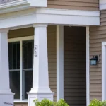 porch column close up with house number and black entry door