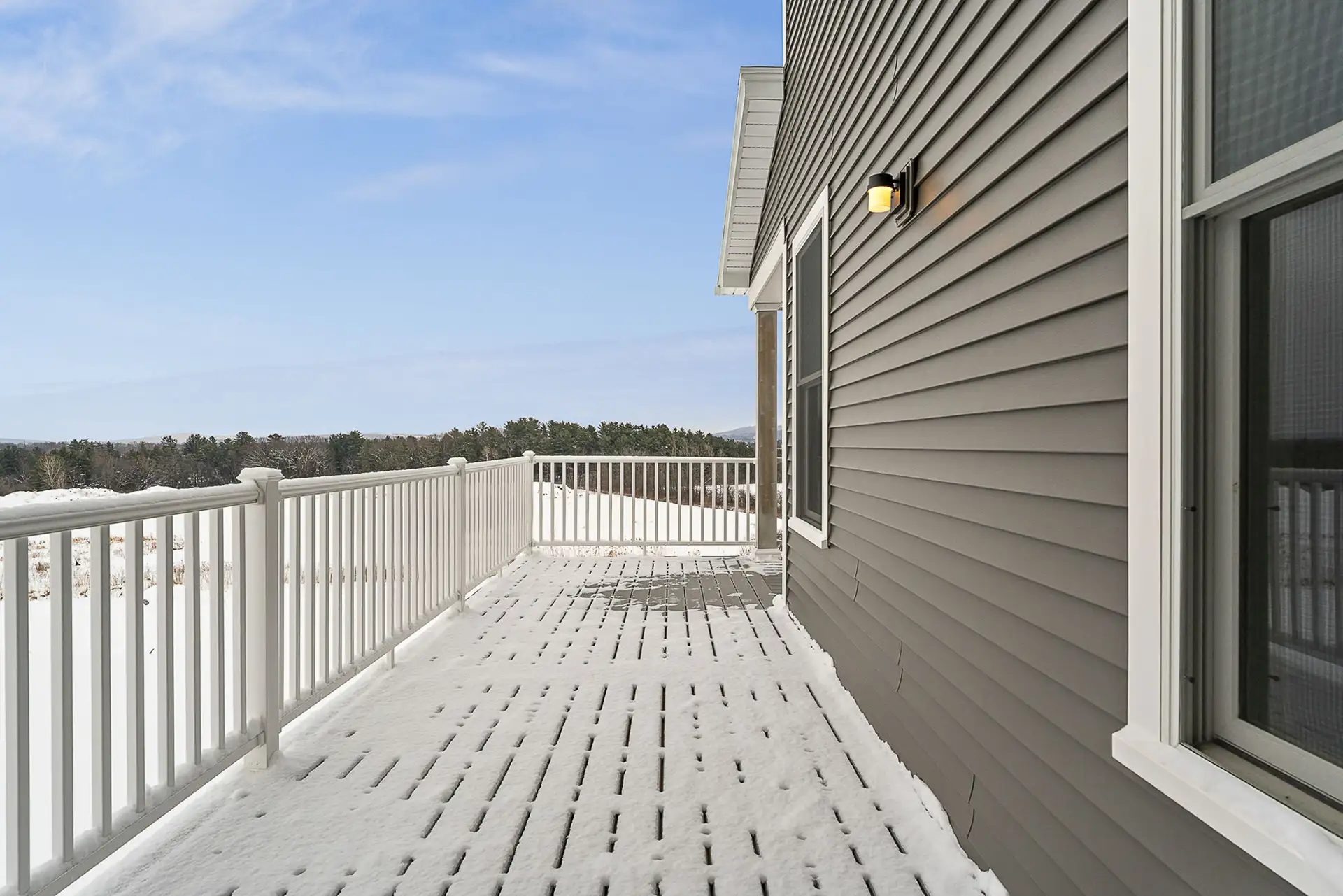 snow covered upper deck with winter landscape view
