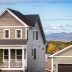 white home rear with solar panels upper deck and patio fire bowl