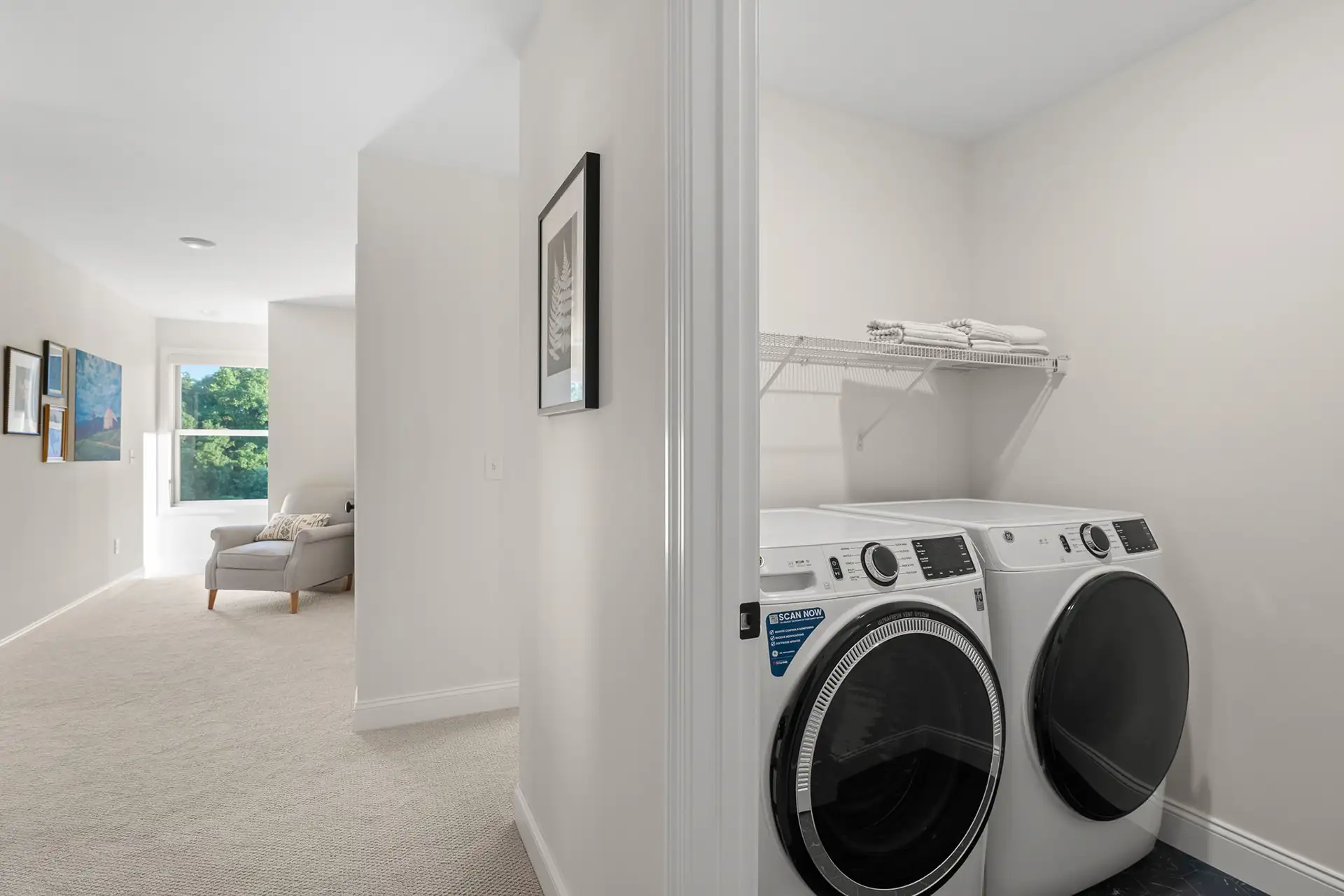 upper floor laundry white washer dryer view to hallway