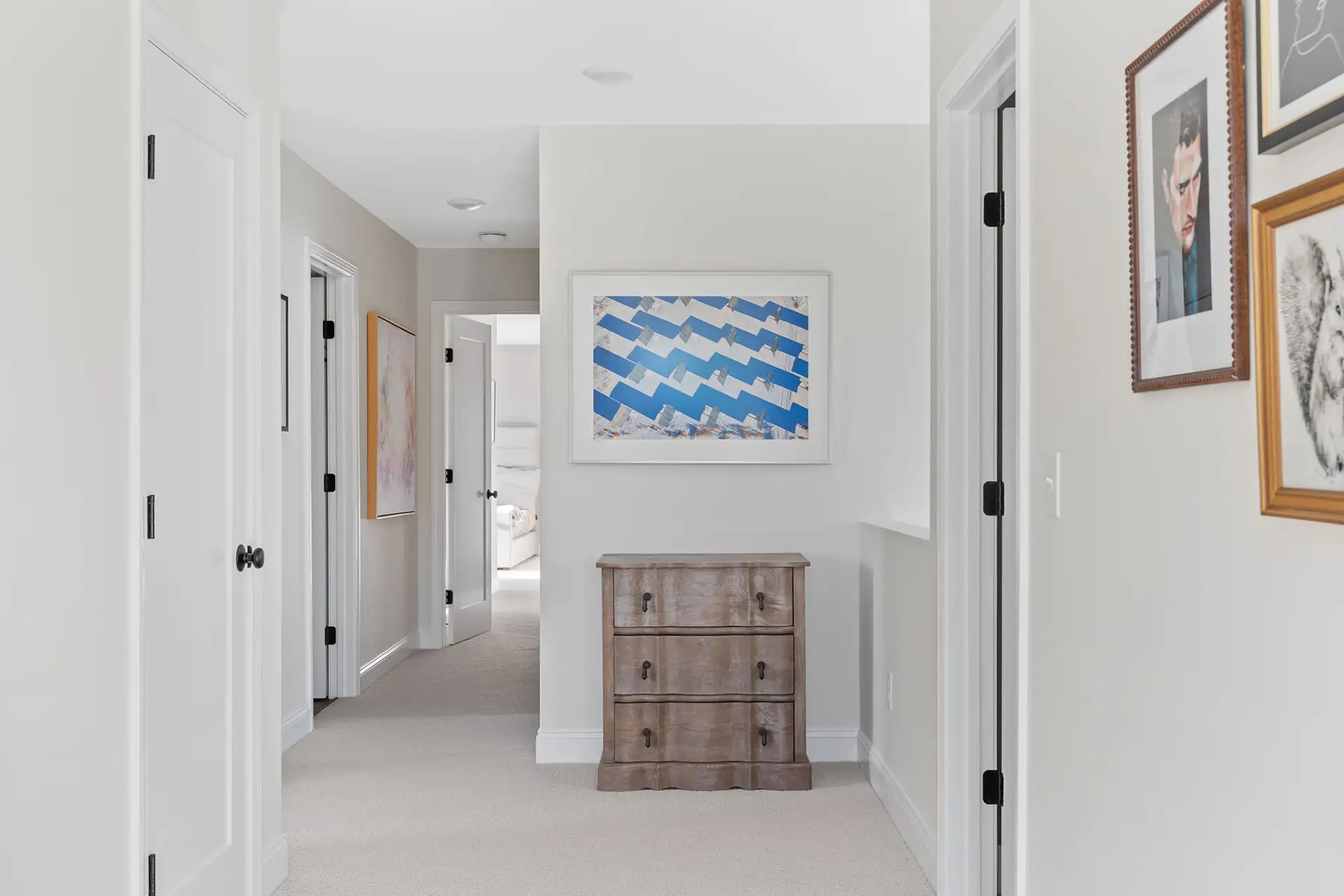 upper hallway carpet art gallery wood dresser multiple doors