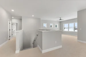 upper hallway landing with staircase and clerestory windows