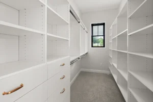 walk in closet white built ins gold hardware hanging rods window