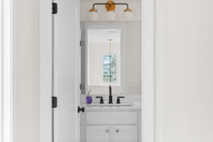 white bathroom vanity gold light mirror view
