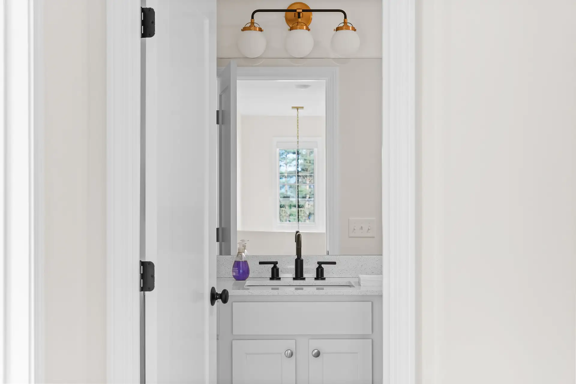 white bathroom vanity gold light mirror view
