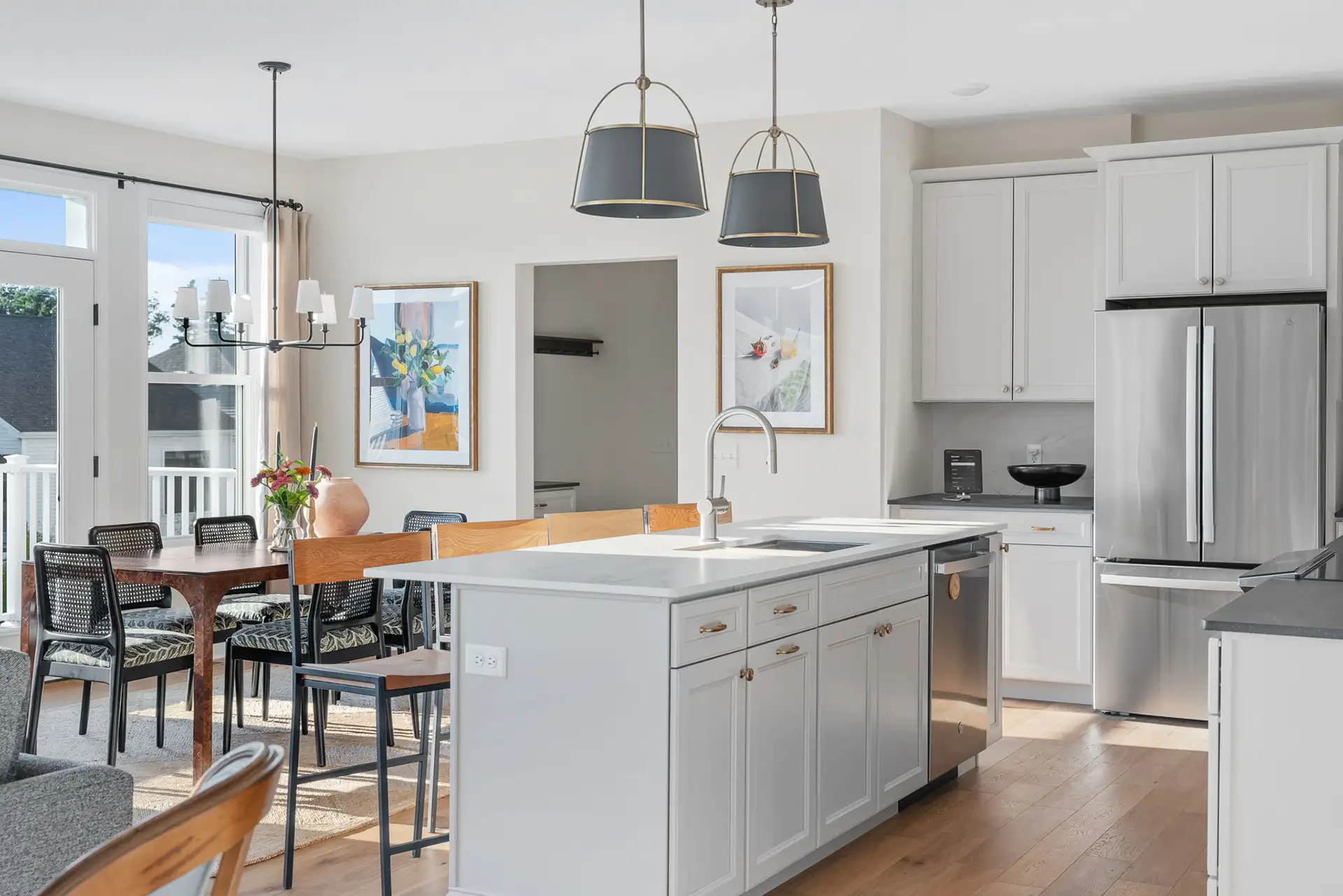 white kitchen island sink dining area gold drum pendants