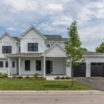 two car garage interior with open door and snowy driveway