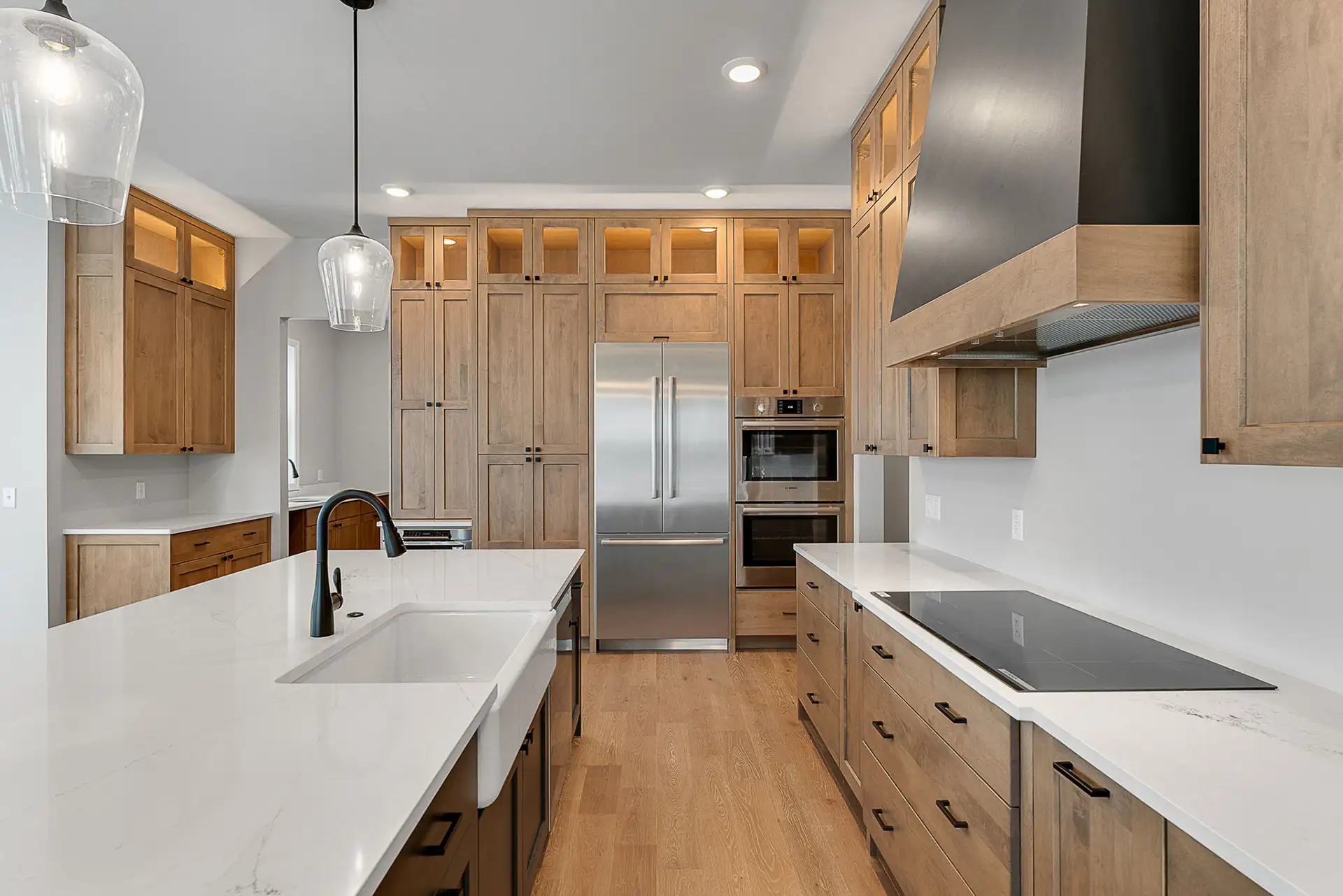 wood kitchen farmhouse sink island black range hood closeup