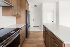 wood kitchen galley view stainless range fridge back door